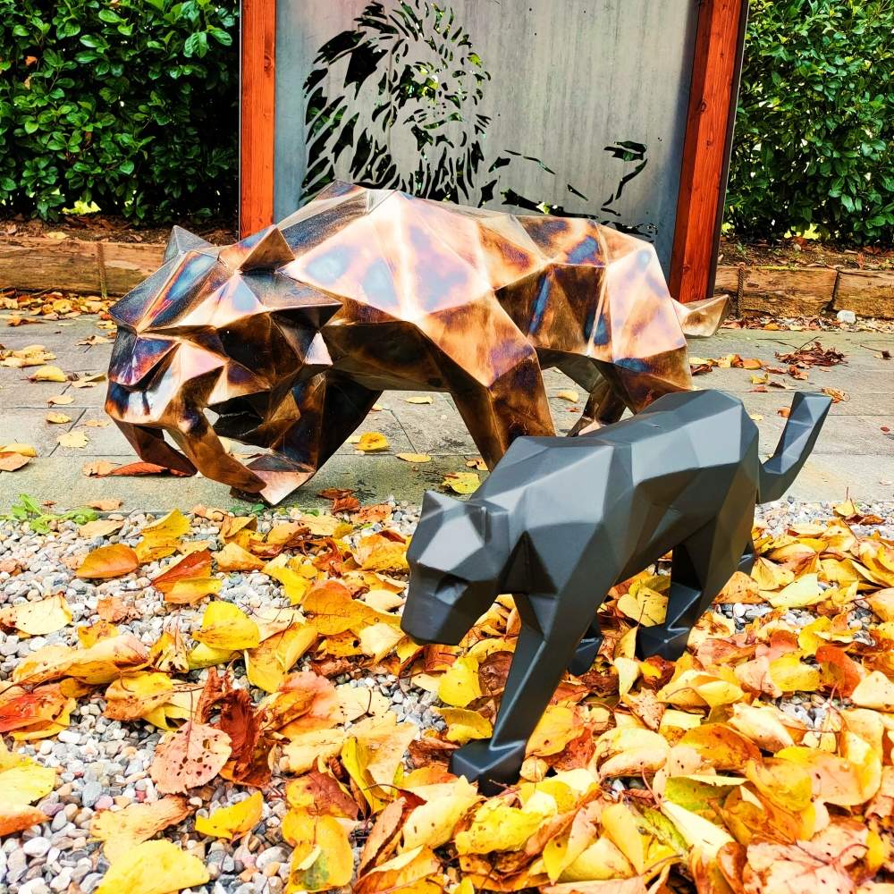 Polygonal welded metal sculpture of a saber-toothed tiger with a panther, handcrafted
